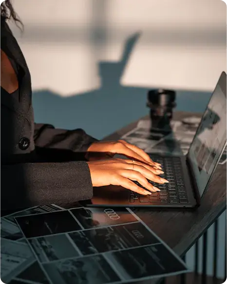 Woman working on laptop with proposal documents